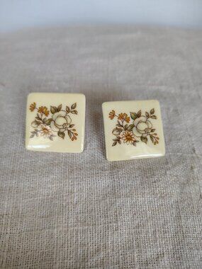Vintage floral design push back earrings on ceramic tiles.